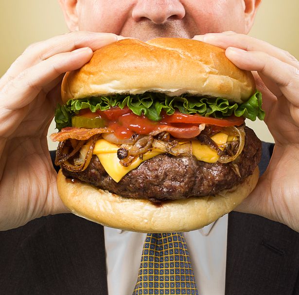 man-biting-into-big-bacon-cheeseburger
