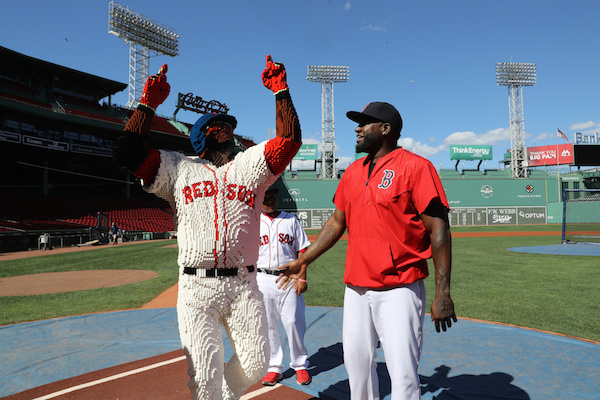 IMAGE DISTRIBUTED FOR LEGO∆ SYSTEMS, INC. - In this image released on Wednesday, Aug. 31, 2016, Boston Red Sox designated hitter David Ortiz reacts to his life-size LEGO likeness that was installed on the Kids Concourse at Fenway Park in Boston before LEGO Day at Fenway Park. From behind, his son D'Angelo Ortiz studies the LEGO Big Papi model made of over 34,500 bricks. (Damian Strohmeyer/AP Images for LEGO∆ Systems, Inc.) ORG XMIT: CPANY305