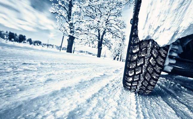 Car tires on winter road